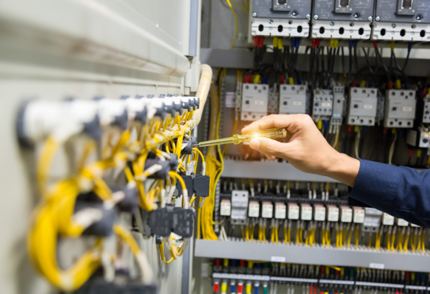 Electricians Hands Testing Current Electric Control Panel 1