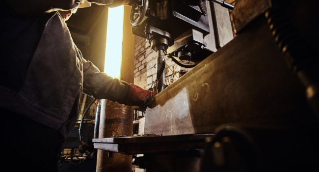 Man Is Working With Giant Drill Busy Metal Factory 1